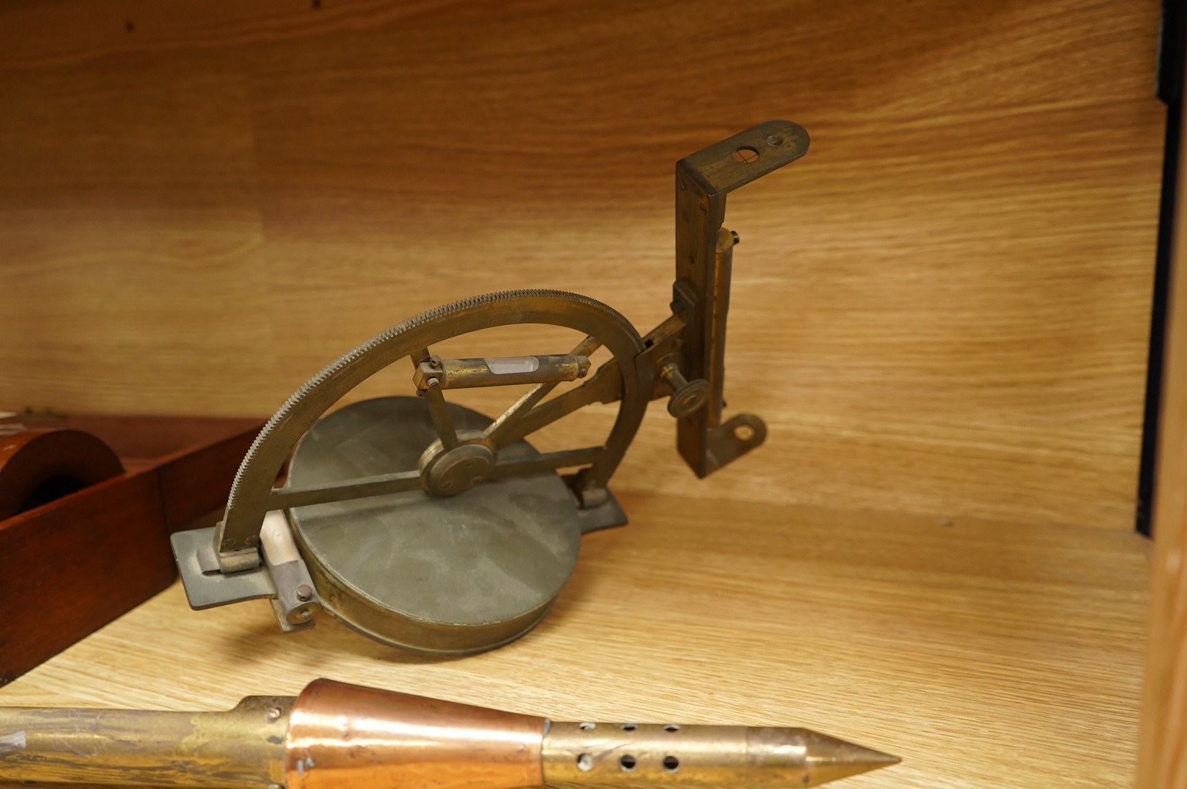 A brass and glass thermometer, with an ash handle, together with an early 19th century brass mining theodolite, by William Wilton, St. Day, Cornwall, (2)